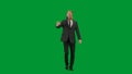 Man in business suit with horse head mask on green studio background. Businessman walking and waving hello. Concept of Royalty Free Stock Photo