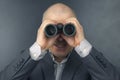 Man in a business suit looks through binoculars. goals in a successful business Royalty Free Stock Photo