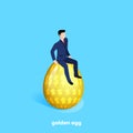A man in a business suit sits on a large golden egg