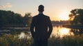 A man in a business suit stands alone hands in pockets gazing out at the peaceful scene before him perhaps finding Royalty Free Stock Photo