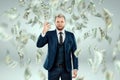 A man in a business suit tosses dollars up, it rains money. Business concept, bookmaker, sports betting, investment, passive Royalty Free Stock Photo