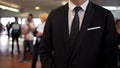 Man in business suit waiting for arrivals in airport hall, travel agent, tourism Royalty Free Stock Photo