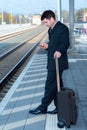 Man on business trip using his smartphone Royalty Free Stock Photo
