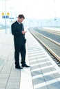 Man on business trip using his smartphone Royalty Free Stock Photo