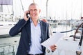 Man businessman communicates on a mobile phone with in the port near