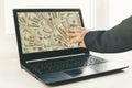 Guy or businessman holding buck money in his hand. Laptop in the background Royalty Free Stock Photo