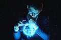 Man businessman holding hands over a blue glowing plasma sphere. Magic prediction and foresight in business and Finance