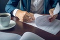 Businessman signs important legal documents on the desktop with Cup of coffee Royalty Free Stock Photo