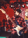 Man with busy face holds guitar, play music,