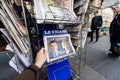 Man buying international press with Emmanuel Macron and Marine l