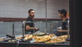 Man buying pizza at night in New York