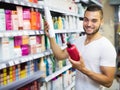 Man buying shampoo Royalty Free Stock Photo