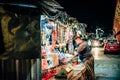 EL SALVADOR - DECEMBER 25: Man buying at a street corner store in dowtown at night, December 25, 2019 in San Salvador, El