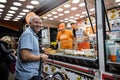 A man buying sweet churros at Santa Iria Festival in Faro, Portugal