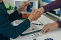 Man buys car and shakes hands with business salesman, closing car sales agreement, gesture and concept of giving keys to new owner Royalty Free Stock Photo