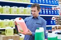 Man buys windshield washer fluid in shop Royalty Free Stock Photo