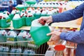 Man buys windshield washer fluid in shop Royalty Free Stock Photo