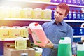 Man buys windshield washer fluid in shop Royalty Free Stock Photo