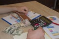 Man, Calculator and money thai banknote on wooden table. The concept of financial planning, savings. Business Objects in the offic Royalty Free Stock Photo