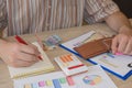 Man, Calculator and money thai banknote on wooden table. The concept of financial planning, savings. Business Objects in the offic Royalty Free Stock Photo