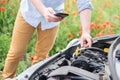 Man calling for help with mobile phone. Broken down car on the road