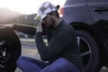 Man calling road assistance on the highway. Calling car service, assistance or  tow truck while having troubles with his car Royalty Free Stock Photo