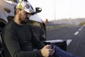 Man calling road assistance on the highway. Calling car service, assistance or  tow truck while having troubles with his car Royalty Free Stock Photo