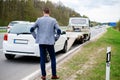 Man calling while tow truck picking up his broken car Royalty Free Stock Photo