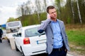 Man calling while tow truck picking up his broken car Royalty Free Stock Photo