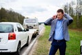 Man calling while tow truck picking up his broken car Royalty Free Stock Photo