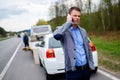 Man calling while tow truck picking up his broken car Royalty Free Stock Photo