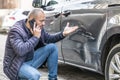 A man calls the insurance company because of the damaged door of his car because the culprit of the accident ran away from the