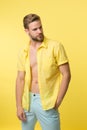 Man calm face posing confidently yellow background. Guy wear unbuttoned shirt with smooth skin on chest. Hair removal