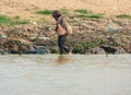 Man from Cambodian slums in the muddy water of Tonle Sap lake-Siem Reap, Cambodia 02/21/2011 .