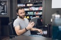 A man looks at the tablet in the barber`s chair in a man`s barbershop. Royalty Free Stock Photo