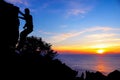 Man with camera climbing rock on the mountain