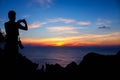 Man with camera climbing rock on the mountain