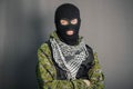 A man in camouflage and bullet proof vest, with a balaclava on his head. A special unit soldier, a modern warrior.