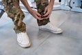Man puts his leg special fixing cuff for exercising simulator