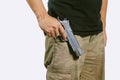 Man in a camouflage pants holding a gun isolated on white background