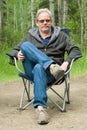 Man in Camping Chair Outside Royalty Free Stock Photo