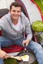 Man On Camping Holiday Frying Egg In Pan Royalty Free Stock Photo