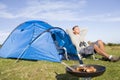 Man camping outdoors and cooking Royalty Free Stock Photo