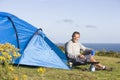 Man camping outdoors and cooking Royalty Free Stock Photo