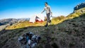 A man camping in the wilderness with a bottle of water in his hand. Norway, Preikestolen.