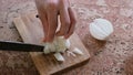 Man can`t cut a bow, he freaks out and throws a knife on the board. Close-up of man`s hands.