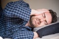 Man can`t sleep in bed suffering insomnia Royalty Free Stock Photo