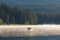 Man on a canoe. Mountains reflect over the calm waters of Sparks Lake at sunrise in the Cascades Range in Central Oregon, USA Royalty Free Stock Photo