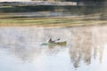 Man on a canoe. Mountains reflect over the calm waters of Sparks Lake at sunrise in the Cascades Range in Central Oregon, USA Royalty Free Stock Photo