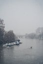Man in canoe on a snowy Sunday morning on the river Thames
